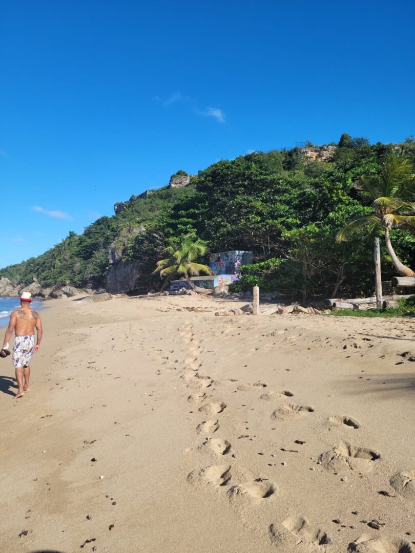 A couple of people walking on the beach