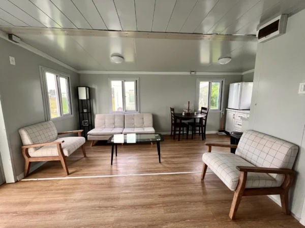 A living room with white walls and wooden floors.