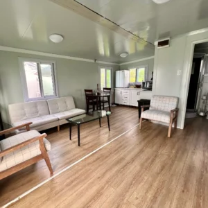 A living room with wooden floors and white walls.