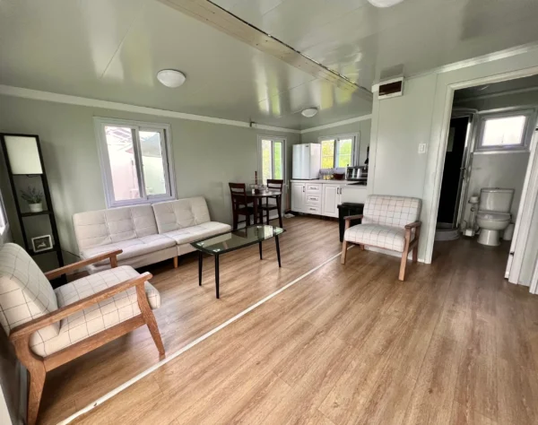 A living room with wooden floors and white walls.