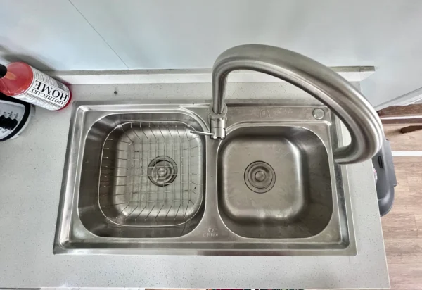 A sink with two sinks and a faucet.