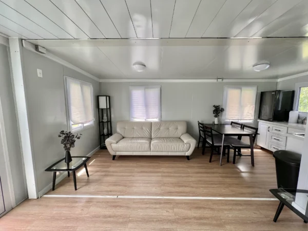 A living room with white walls and wooden floors.