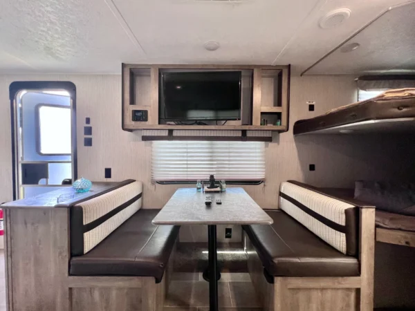 A table and chairs in the back of an rv.